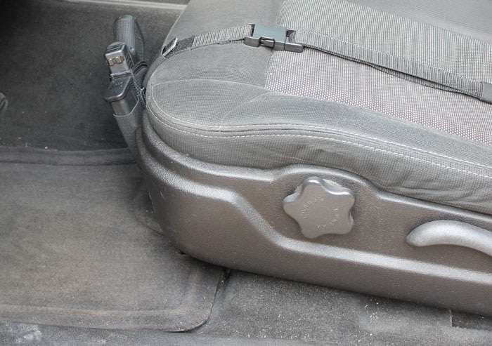 side view of a gun strapped to car seat