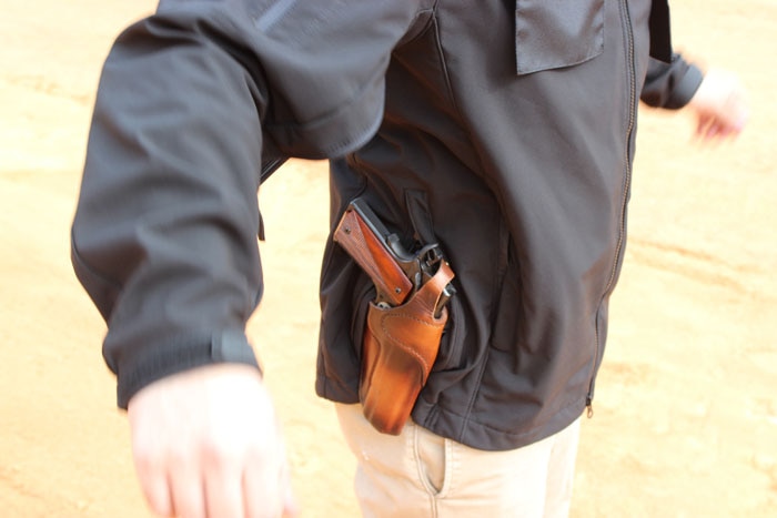 gun holstered in condor haze jacket