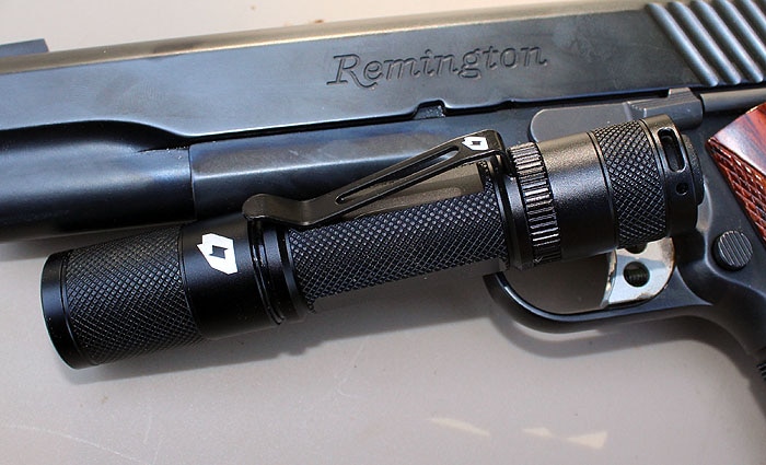 flashlight next to a remington shotgun