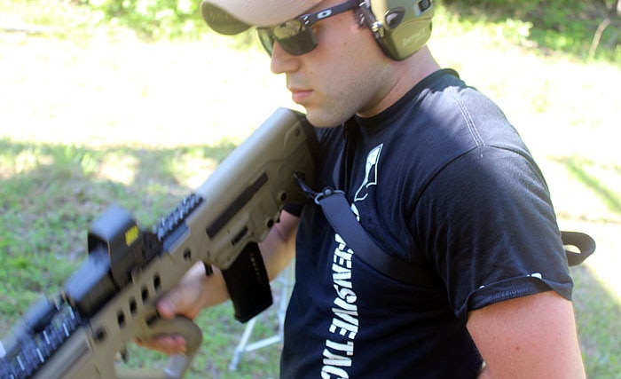 male shooter with magpul sling on rifle