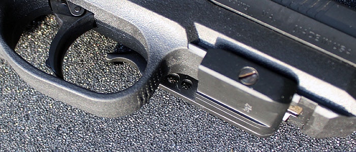 muzzle and trigger view of handgun on blacktop