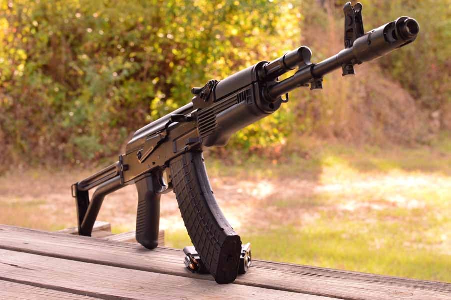AK rifle stood up on picnic table