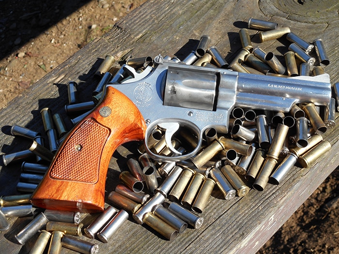 sw model 66 revolver on top of empty bullet casings