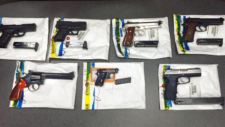 The Baltimore Police Department found these guns during a recent raid on the Safe Streets offices on E. Monument Street in July.  (Tom Brenner / Baltimore Sun)