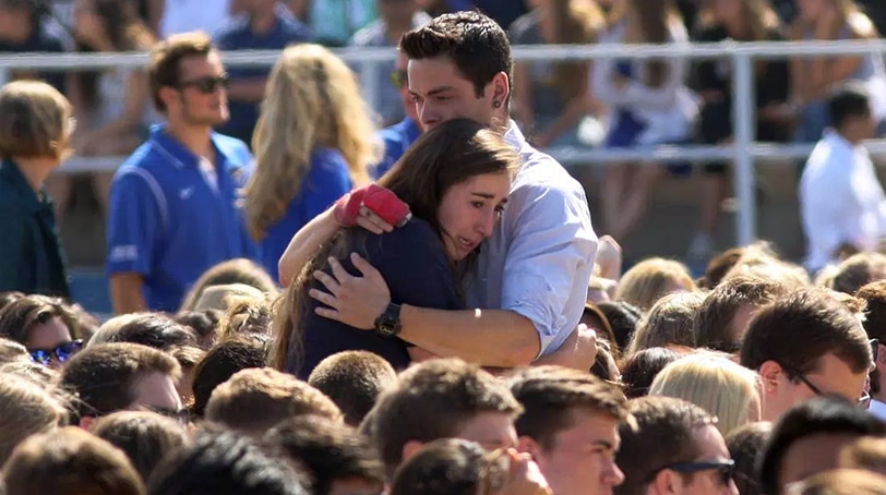 People hug at a public memorial on the Day of Mourning and Reflection for the victims of a killing spree at University of California, Santa Barbara on May 27, 2014 in Isla Vista, California. (Photo: Getty Images)