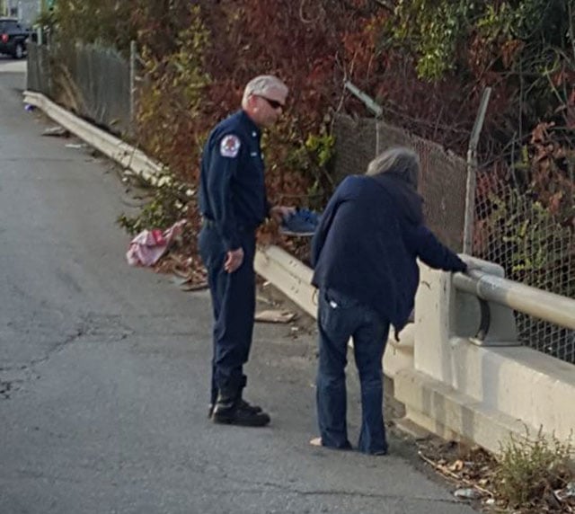 firefighters give shoes to homeless man
