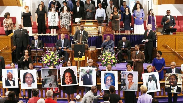 Pictures of the nine people gunned down at the Emanuel AME Church in Charleston were held up by congregants during a prayer vigil at the the Metropolitan AME Church in Washington, D.C. (Photo: Win McNamee/Getty Images)