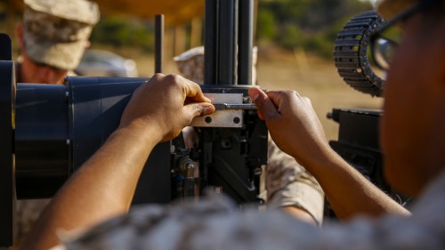 Lance Cpl. Jorge Sainz, a rifleman with Kilo Company, 3rd Battalion, 5th Regiment, attaches the M134 Minigun to the Robotic Vehicle Modular system aboard Camp Pendleton, June 23, 2016. The Marines were learning how to operate the system which is going to be tested during Rim of the Pacific 2016 with partner nations. The RVM is designed to assist an infantry platoon by providing more fire power, bearing equipment loads and designating targets for air assaults. The Marine Corps Warfighting Laboratory is conducting a Marine Air-Ground Task Force Integrated Experiment to explore new gear and access its capabilities for potential future use. (U.S. Marine Corps photo by Lance Cpl. Frank Cordoba/Released)