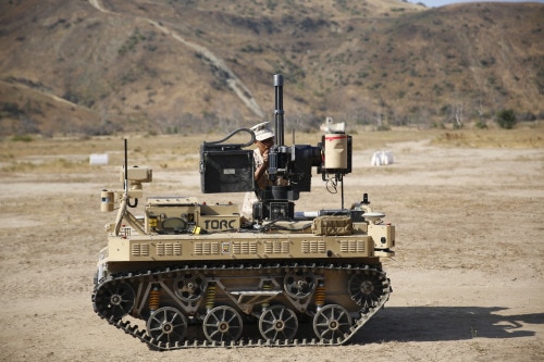 Lance Cpl. Jorge Sainz, a rifleman with Kilo Company, 3rd Battalion, 5th Regiment attaches the M134 Minigun to the Robotic Vehicle Modular system aboard Camp Pendleton, June 23, 2016. He and other Marines from his unit will be using the system during the exercise Rim of the Pacific. The Marine Corps Warfighting Laboratory is conducting a Marine Air-Ground Task Force Integrated Experiment to explore new gear and access its capabilities for potential future use. (U.S. Marine Corps photo by Lance Cpl. Frank Cordoba/Released)