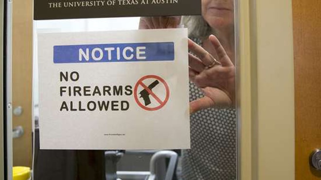 A UT professor posts a sign prohibiting guns at her office at the Student Activity Center on the first day of the new campus carry law last month. (Photo: The Statesman)