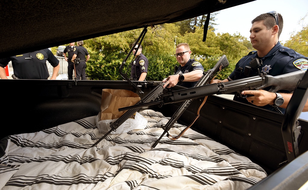 San Rafael Police officers David Casalnuovo, left, and Anthony Scalercio remove rifles from the back of this pick-up during a gun buyback at the San Rafael Police department on Tuesday, Sept. 13, 2016. (Photo: Robert Tong/Marin Independent Journal)