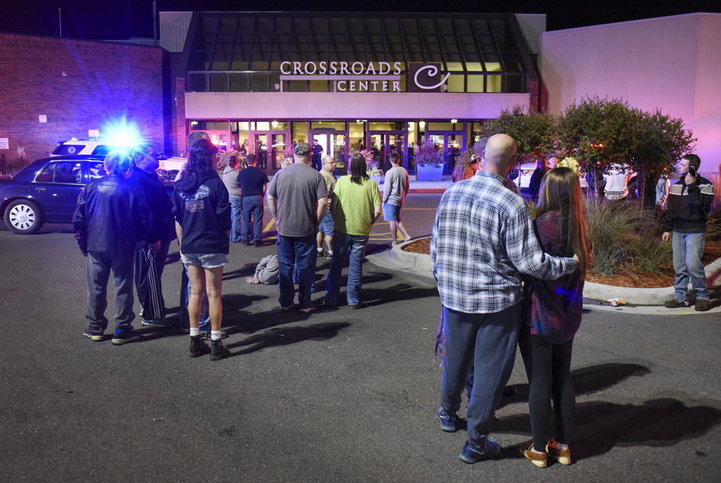 Shoppers stand near an entrance to Crossroads Mall where a man stabbed nine people before an off-duty cop shot and killed the suspect. (Photo: Dave Schwarz/Associated Press)