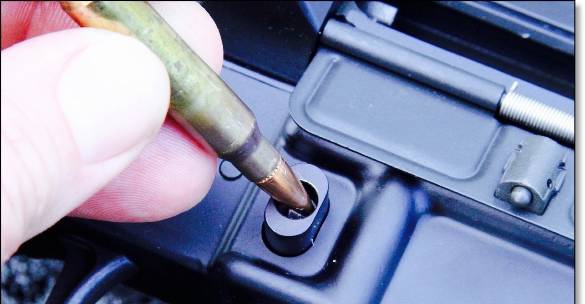 A "bullet button" requires a special tool to detach a magazine from a rifle, though a bullet can also be used. (Photo: GunsAmerica.com) 
