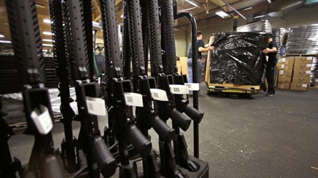 A rack of AR-15 rifles stand to be individually packaged as workers move a pallet of rifles for shipment at the Stag Arms company in New Britain, Conn., Wednesday, April 10, 2013. (Photo: Associated Press)