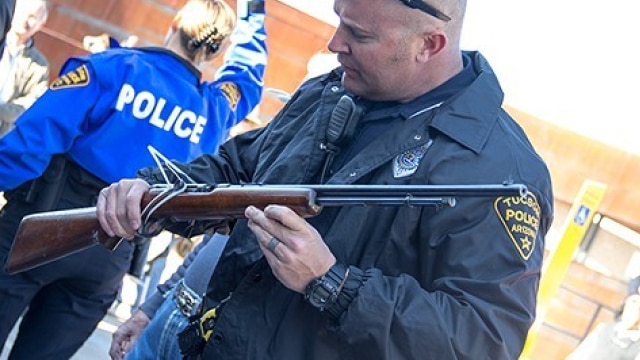 Officer Eric Coutts is checking the serial number on the rifle at the gun buyback event at the Midtown Tucson Police Department Substation on Tuesday, Jan. 8, 2012 in Tucson, Ariz. (Photo: Noelle Haro-Gomez/Tucson Weekly) 