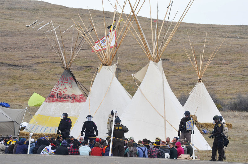 Law enforcement decked out in riot gear moved in on protestors rallying against the Dakota Access pipeline. (Photo: Amy Sisk/Prairie Public Broadcasting)