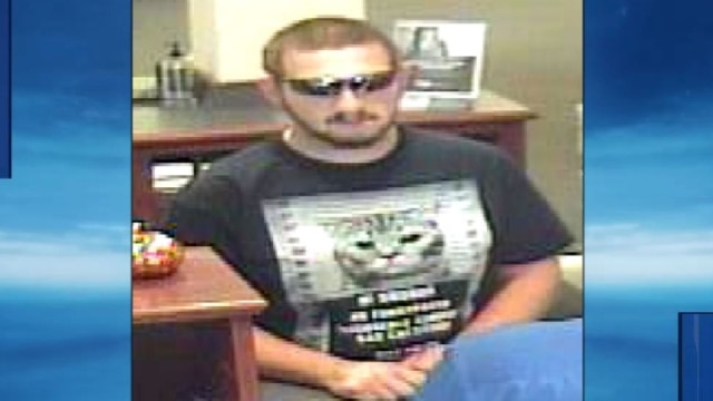 The suspect is wearing what appears to be a Mr. Furrypants mug shot tee. (Photo: FBI via KOCO https://www.koco.com/article/norman-police-investigate-bank-robbery/7157976 ) 