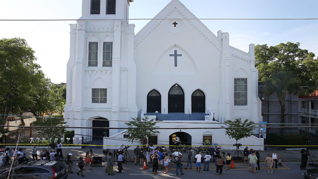 People stand outside the Emanuel AME Church after a mass shooting at the church that killed nine people on June 18, 2015, in Charleston, South Carolina. A 21-year-old suspect, Dylann Roof of Lexington, South Carolina, was arrersted Thursday during a traffic stop. Emanuel AME Church is one of the oldest in the South. (Photo: Joe Raedle/Getty Images)