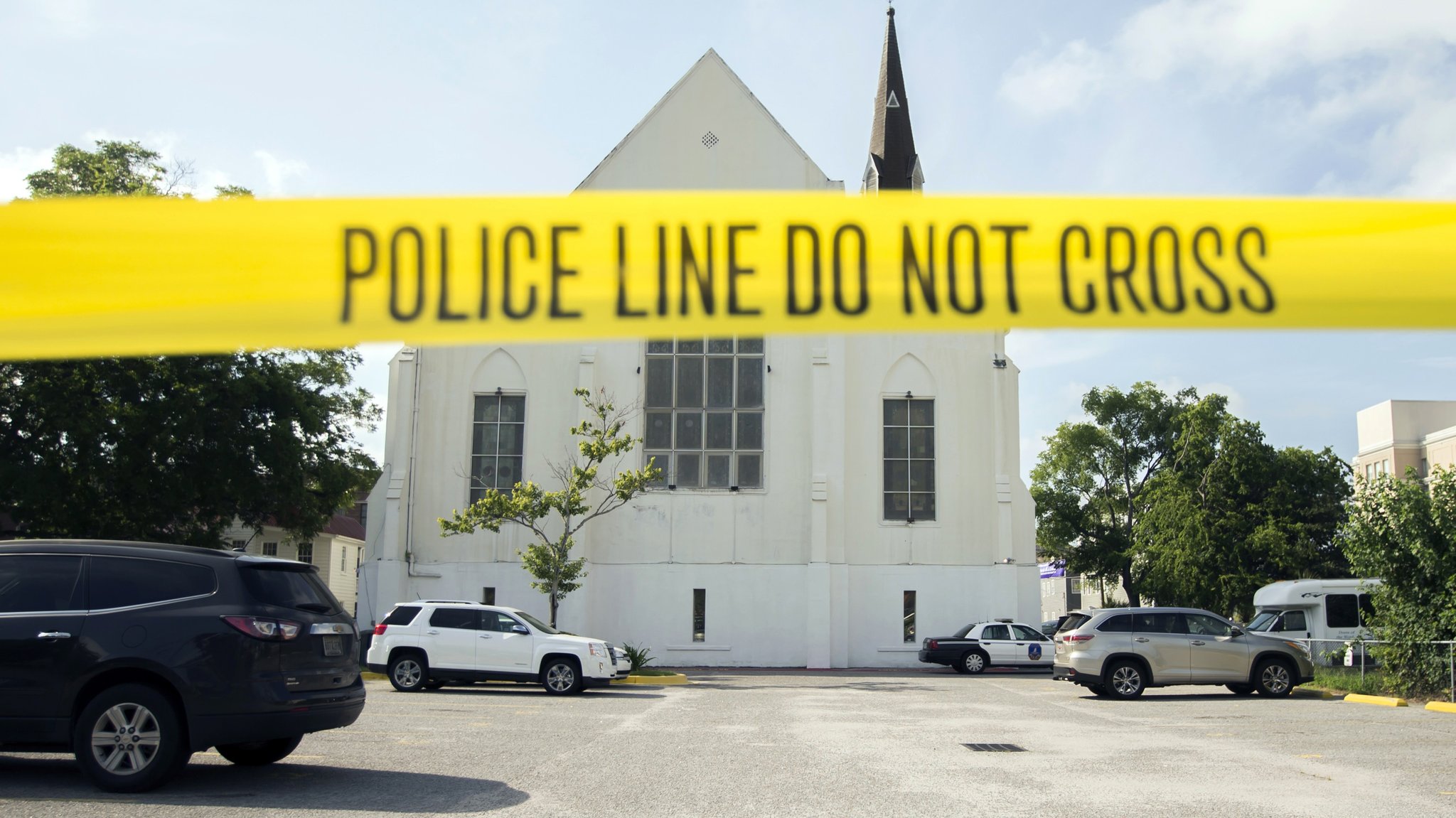Police tape surrounds the parking lot behind the AME Emanuel Church as FBI forensic experts work the crime scene, Friday, June 19, 2015 in Charleston, S.C. (Photo: Stephen B. Morton/AP Photo)