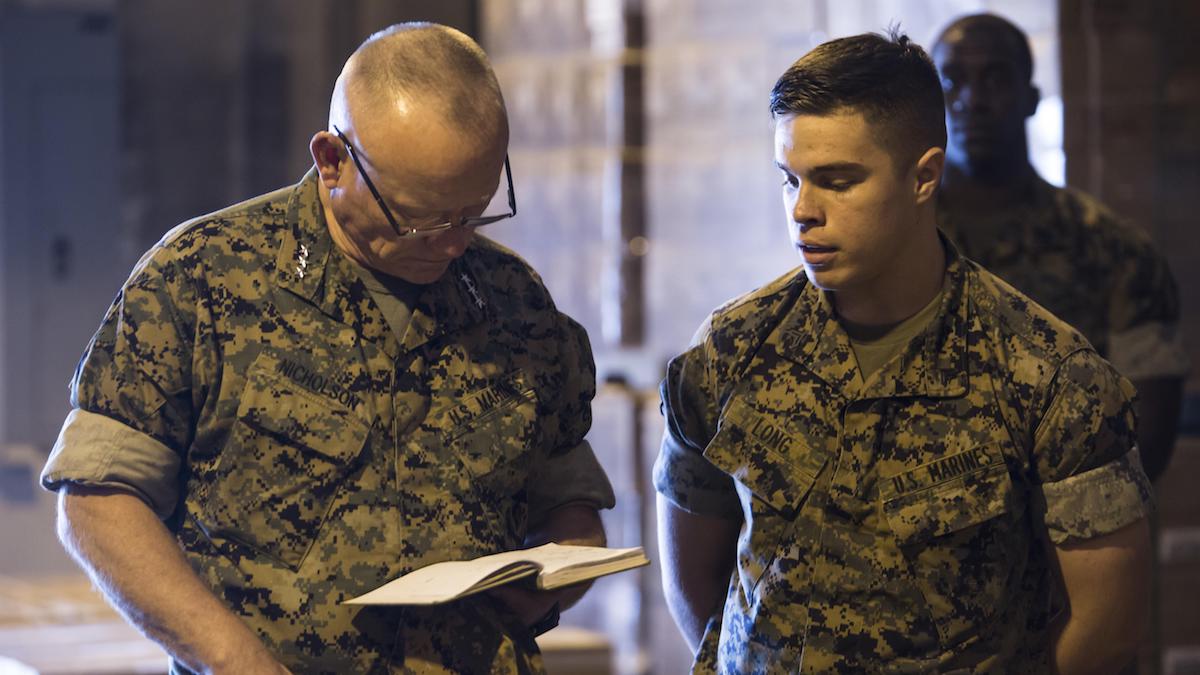 Marine Corps Lt. Gen. Lawrence Nicholson, left, commander of the III Marine Expeditionary Force, reviews Cpl. Matthew Long's design. (Photo: Sgt. William Hester)