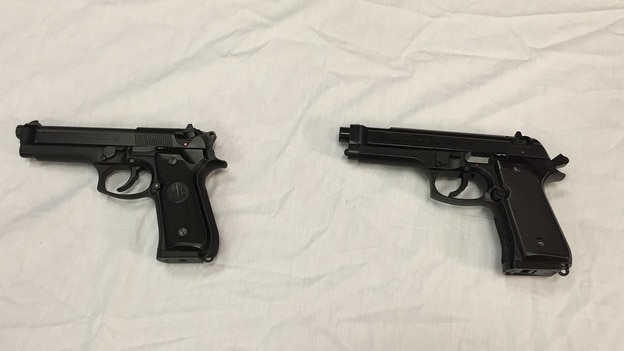 Police display Colvin's replica gun, right, next to a semi-automatic handgun, pictured left. (Photo: Juliet Linderman/AP)