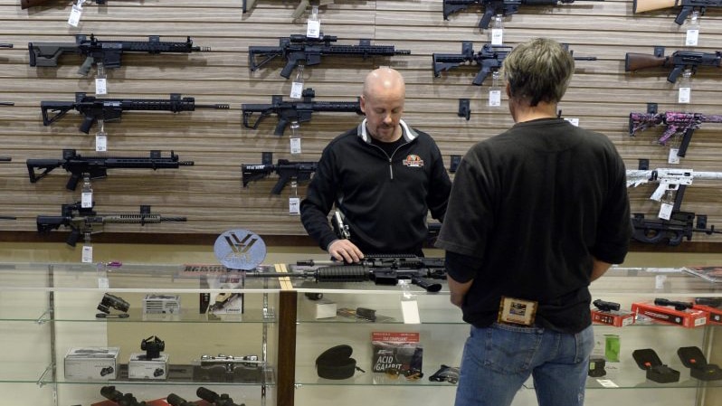 A customer looks at rifles at a Colorado gun shop in this January 2016 file photo (Photo: Andy Cross/Denver Post)