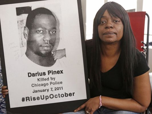 Gloria Pinex holds the photo of her son Darius Pinex, 27, who was fatally shot by police in 2011. (Photo: M. Spencer Green/AP)