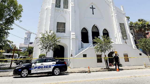 Charleston, S.C., police officers stand in front of the Emanuel African Methodist Episcopal Church on Thursday (Photo: Stephen B. Morton/AP)