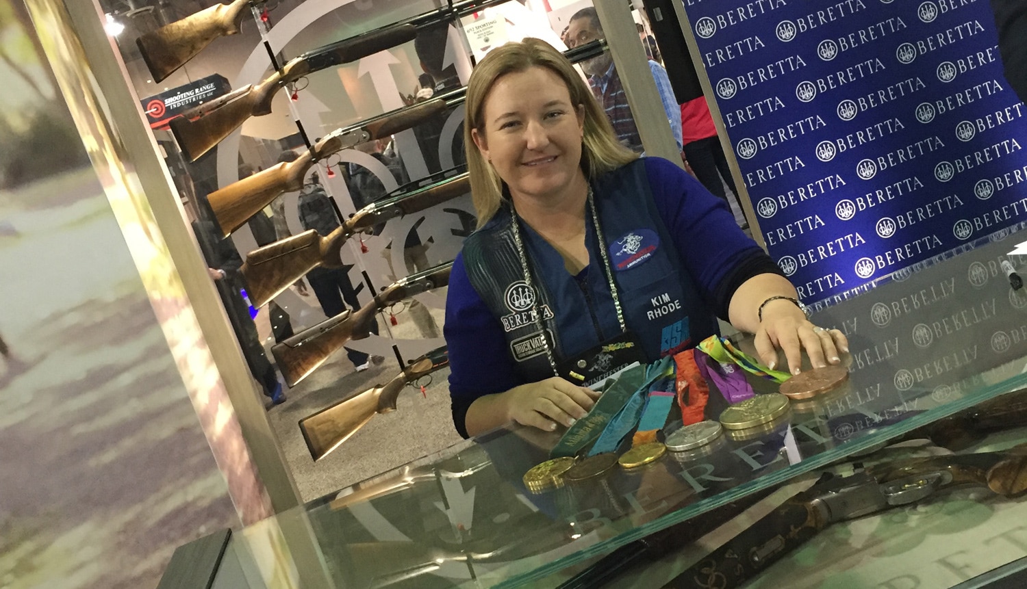 Six-time Olympic medal winner Kim Rhode appeared at the Beretta booth for a meet and greet with fans. In her display case sits the Beretta DT11 shotgun, the gun used to win 10 of 15 medals at the summer Olympic games. (Photo: Daniel Terrill/Guns.com) 