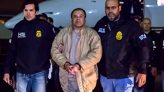 Joaquin “El Chapo” Guzman, center, being escorted by two federal agents. (Photo: HSI)