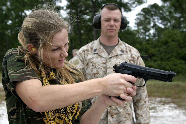 A Marine spouse shoots at a target with a M9 9mm pistol. (Photo: U.S. Marine Corps)