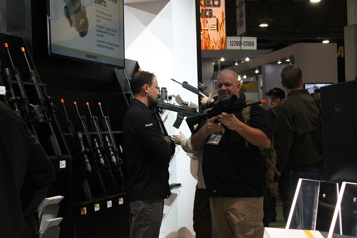A SHOT Show attendee checking out Sig's air soft rifle selection. (Photo: Jacki Billings)