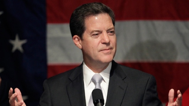 Kansas Gov. Sam Brownback signed the Kansas Second Amendment Protection Act into law in 2013 (Photo: Politico)