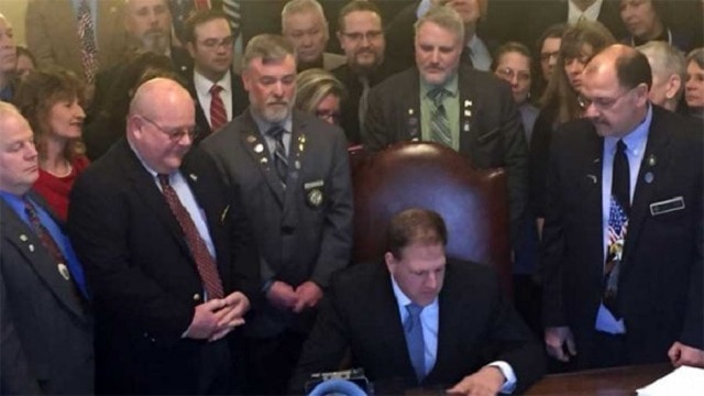 N.H. Gov. Chris Sununu signs the constitutional carry bill into law (Photo: NRA-ILA)
