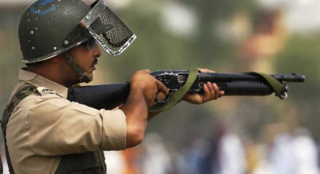 An Indian policeman aim his pellet gun at protesters during a protest in Srinagar, India (Photo and caption: AP) 
