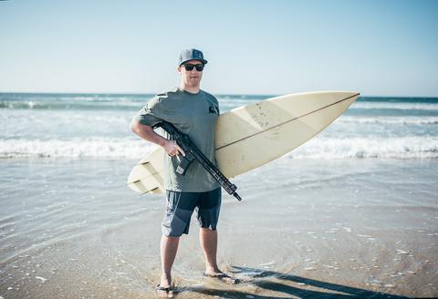 Alex West, founder of One More Wave, with the Gen III OMW rifle. West's organization provides surfboards for disabled vets. (Photo: Noveske Rifleworks) 