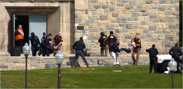 Emergency workers carried people from Norris Hall on the campus of Virginia Tech in Blacksburg, Va., on Monday after a gunman killed 32 people. (Photo: Alan Kim/The Roanoke Times, via Associated Press)