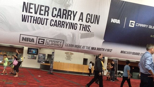 The NRA greeted guests with a sign promoting its new self-defense insurance during the organization's annual conference in Atlanta from April 27-30, 2017. <em>(Photo: Daniel Terrill/Guns.com)</em>