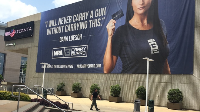 The NRA draped a sign over the side of the Georgia World Congress Center to promote the new self-defense insurance. (Photo: Daniel Terrill/Guns.com)