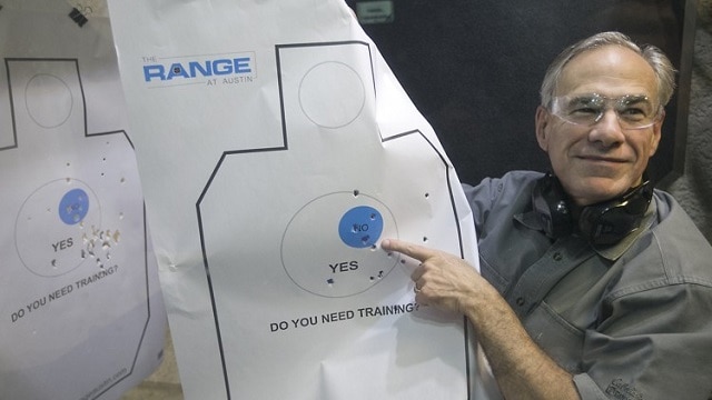 Texas Gov. Greg Abbott holds up his target sheet to reporters after firing off a couple rounds at an Austin shooting range. (Photo: Austin American-Statesman)