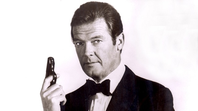 Roger Moore poses as James Bond with his Walther PPK pistol. (Photo: Moviestore/Rex Shutterstock)