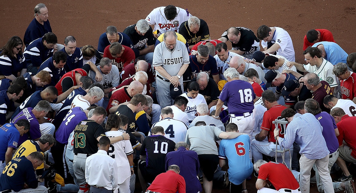 Members of the Republican and Democratic congressional baseball teams gather for a bipartisan prayer before the start of the congressional baseball game at Nationals Park on Thursday. U.S. House Majority Whip Rep. Steve Scalise (R-La.) is in critical condition following a shooting Wednesday during a Republican congressional baseball team practice. Four others were also wounded and the gunman was killed. Getty