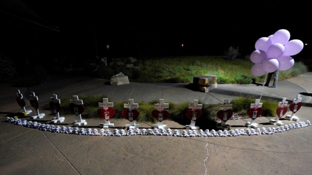 Crosses for those killed in the Aurora movie theater shooting are set up at midnight vigil marking the fifth anniversary of the tragedy. (Photo: Rick Wilking/Reuters)