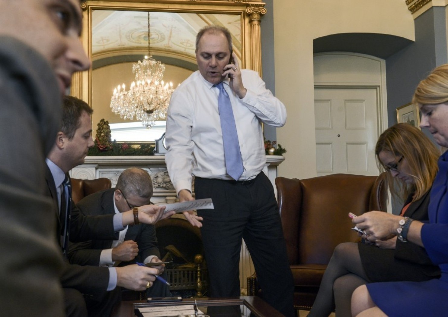 House Majority Whip Steve Scalise (center) meets with staff while checking on his vote count on Dec. 11, 2014, in his Capitol office. (Photo by Bill O’Leary/The Washington Post)