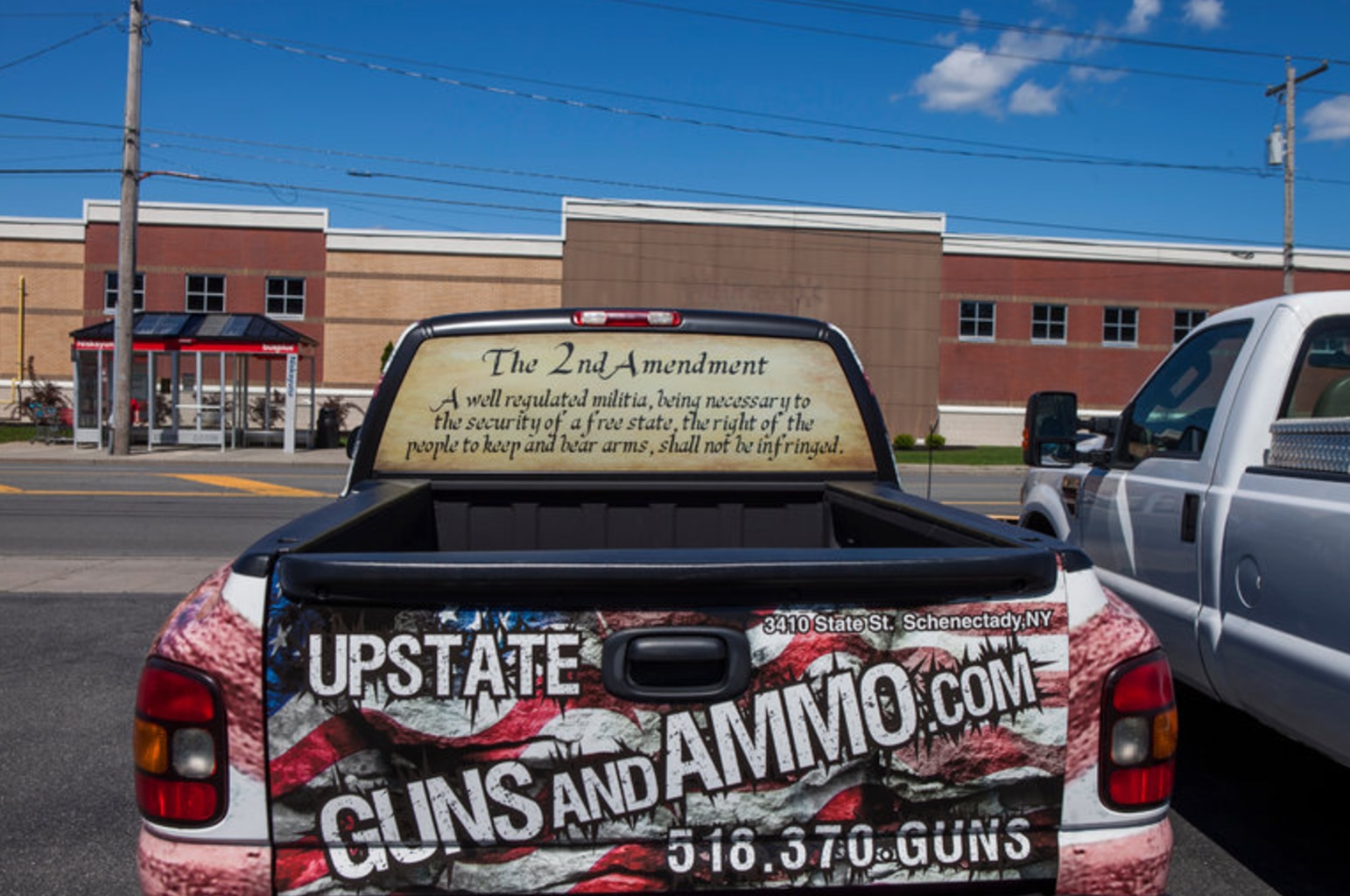 A truck is wrapped in graphics reading Upstate Guns and Ammo, the store Henry Bello legally purchased the AM-15 rifle he used to allegedly kill a clinician and himself after wounding six others at a Bronx hospital last week. (Photo: New York Times)
