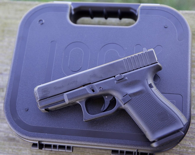 glock 19 pistol sitting on top of case