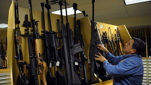ATF Firearms Specialist Richard Vasquez is surrounded by a cache of firearms in the gun vault on March 5, 2010, at the ATF National Tracing Center in Martinsburg, West Virginia. (Ricky Carioti/The Washington Post via Getty Images)