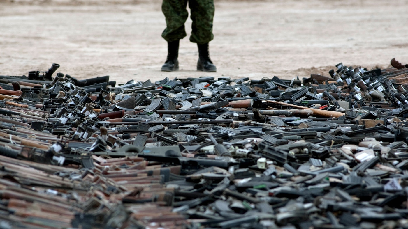A new government report details the problems agencies face in fighting weapons trafficking. Here, thousands of guns lie on the ground before being destroyed in Ciudad Juarez, Mexico, in 2012.
