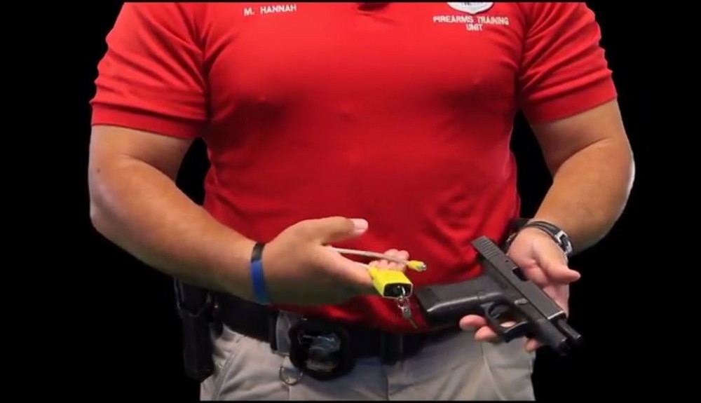 Memphis Police Officer Marion Hannah showing a gun lock during a firearms safety public service announcement. (Photo: MPD/YouTube)