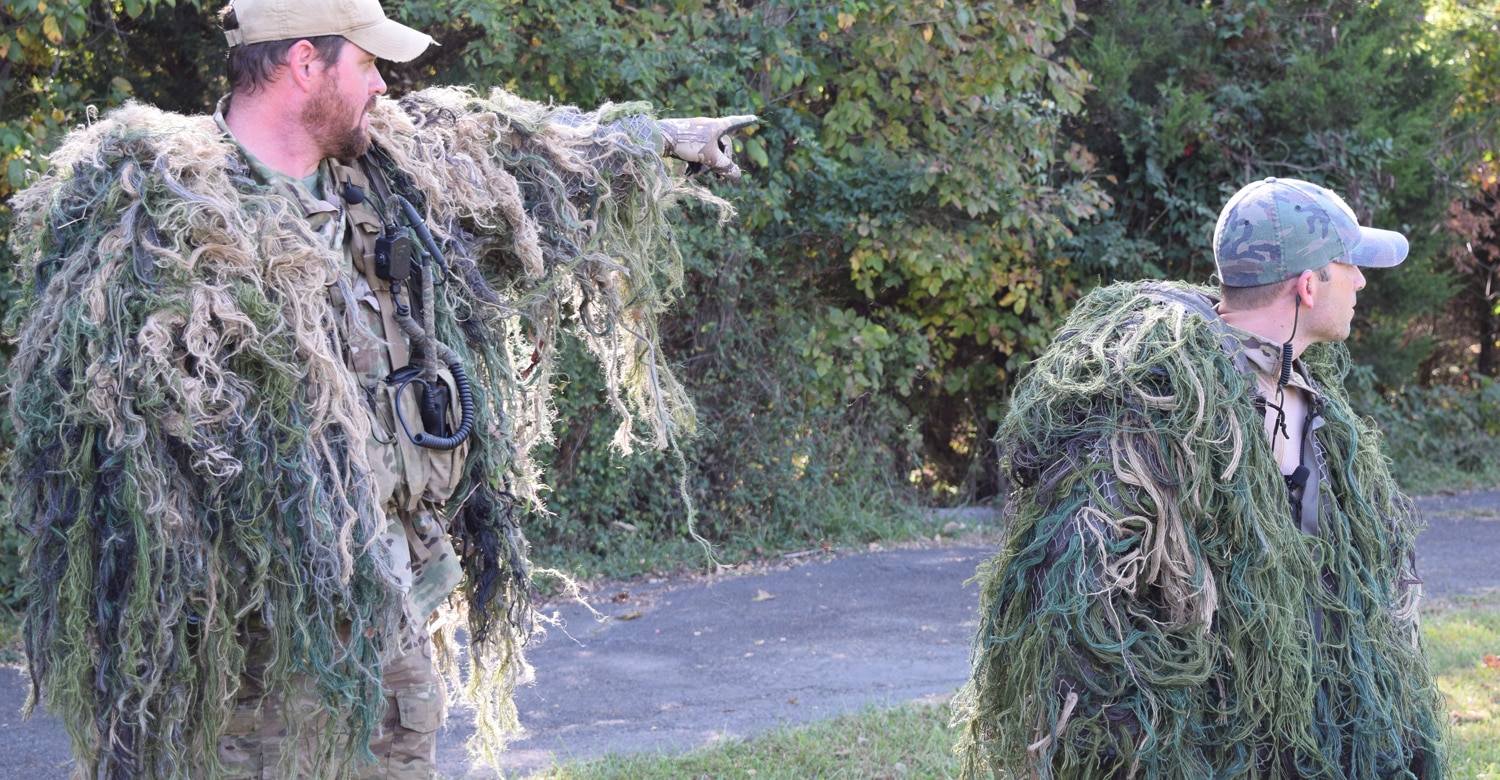 The ATF SRT sniper team wearing guillie suits pointing to where they were hiding in the woods when they shot a pumpkin from 125 yards away. (Photo: Daniel Terrill/Guns.com)